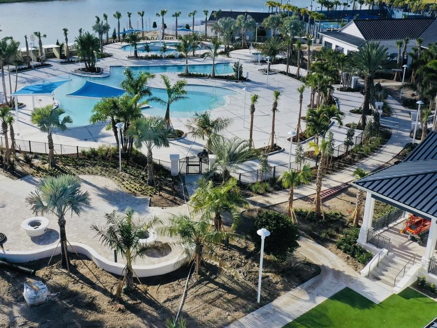 Aerial view of the Del Webb at Viera amenity center, lagoon pool and palms
